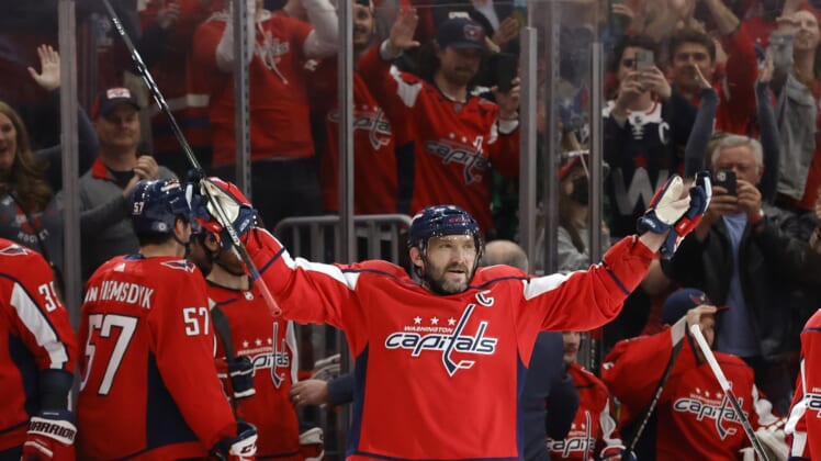 Mar 15, 2022; Washington, District of Columbia, USA; Washington Capitals left wing Alex Ovechkin (8) salutes the fans after scoring a goal against the New York Islanders in the third period at Capital One Arena. It was Ovechkin's 767th NHL goal, moving him into third place in all-time goals. Mandatory Credit: Geoff Burke-USA TODAY Sports