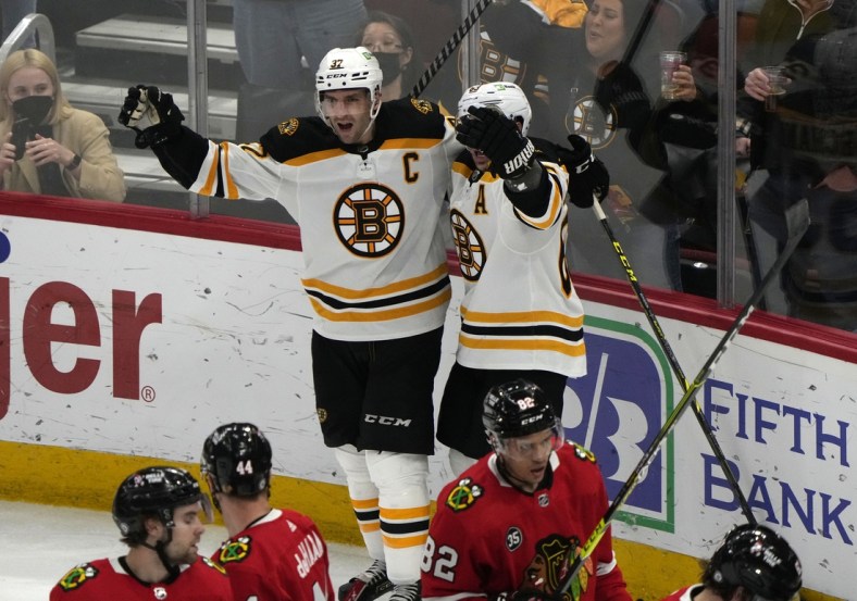 Mar 15, 2022; Chicago, Illinois, USA; Boston Bruins center Patrice Bergeron (37) reacts after scoring a goal against the Chicago Blackhawks during the third period at the United Center. Mandatory Credit: Mike Dinovo-USA TODAY Sports