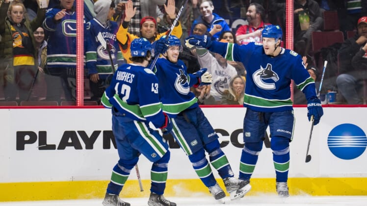 Mar 15, 2022; Vancouver, British Columbia, CAN; Vancouver Canucks defenseman Quinn Hughes (43),  forward Bo Horvat (53) and defenseman Luke Schenn (2) celebrate Horvat   s goal against the New Jersey Devils in the third period at Rogers Arena. Vancouver won 6-3. Mandatory Credit: Bob Frid-USA TODAY Sports