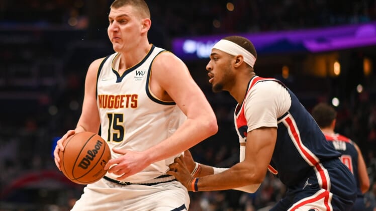 Mar 16, 2022; Washington, District of Columbia, USA;  Denver Nuggets center Nikola Jokic (15) moves the ball as Washington Wizards center Daniel Gafford (21) defends during the first half at Capital One Arena. Mandatory Credit: Tommy Gilligan-USA TODAY Sports