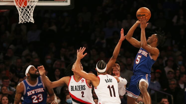 Mar 16, 2022; New York, New York, USA; New York Knicks guard Immanuel Quickley (5) goes up for a shot against Portland Trail Blazers guard Josh Hart (11) and Portland Trail Blazers forward Trendon Watford (2) during the first half at Madison Square Garden. Mandatory Credit: Andy Marlin-USA TODAY Sports
