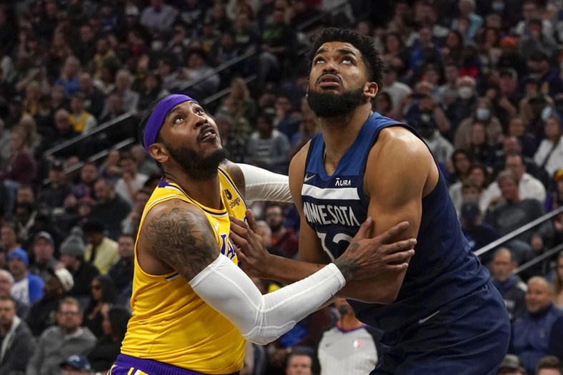 Mar 16, 2022; Minneapolis, Minnesota, USA;  Los Angeles Lakers forward Carmelo Anthony (7) and Minnesota Timberwolves center Karl-Anthony Towns (32) battle for position during the second quarter at Target Center. Mandatory Credit: Nick Wosika-USA TODAY Sports