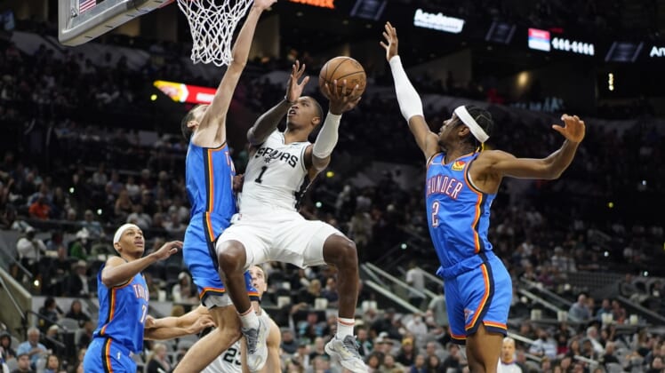 Mar 16, 2022; San Antonio, Texas, USA; San Antonio Spurs guard Lonnie Walker IV (1) shoots while defended by Oklahoma City Thunder guard Shai Gilgeous-Alexander (2) during the first half at AT&T Center. Mandatory Credit: Scott Wachter-USA TODAY Sports
