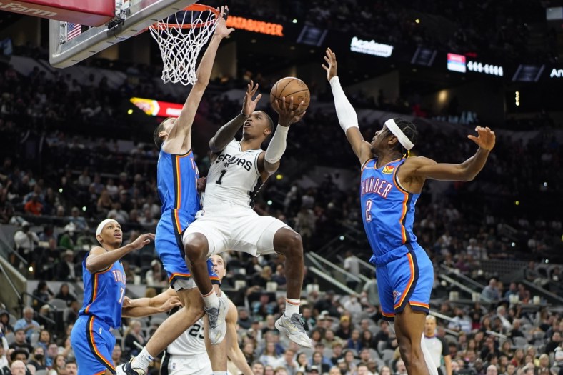 Mar 16, 2022; San Antonio, Texas, USA; San Antonio Spurs guard Lonnie Walker IV (1) shoots while defended by Oklahoma City Thunder guard Shai Gilgeous-Alexander (2) during the first half at AT&T Center. Mandatory Credit: Scott Wachter-USA TODAY Sports