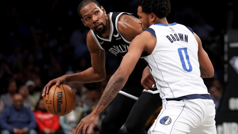 Mar 16, 2022; Brooklyn, New York, USA; Brooklyn Nets forward Kevin Durant (7) controls the ball against Dallas Mavericks forward Sterling Brown (0) during the third quarter at Barclays Center. Mandatory Credit: Brad Penner-USA TODAY Sports