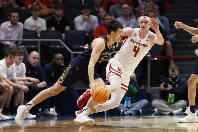 Mar 16, 2022; Dayton, Ohio, USA; Notre Dame Fighting Irish guard Cormac Ryan (5) drives to the basket defended by Rutgers Scarlet Knights guard Paul Mulcahy (4) in the second half at University of Dayton Arena. Mandatory Credit: Rick Osentoski-USA TODAY Sports