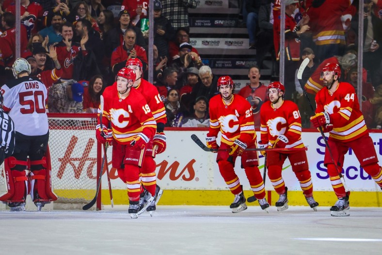 Mar 16, 2022; Calgary, Alberta, CAN; Calgary Flames left wing Matthew Tkachuk (19) celebrates his goal with teammates against the New Jersey Devils during the second period at Scotiabank Saddledome. Mandatory Credit: Sergei Belski-USA TODAY Sports