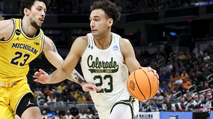 Mar 17, 2022; Indianapolis, IN, USA; Colorado State Rams guard Isaiah Rivera (23) drives to the basket against Michigan Wolverines forward Brandon Johns Jr. (23) in the first half during the first round of the 2022 NCAA Tournament at Gainbridge Fieldhouse. Mandatory Credit: Trevor Ruszkowski-USA TODAY Sports