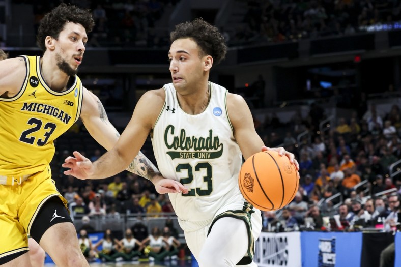 Mar 17, 2022; Indianapolis, IN, USA; Colorado State Rams guard Isaiah Rivera (23) drives to the basket against Michigan Wolverines forward Brandon Johns Jr. (23) in the first half during the first round of the 2022 NCAA Tournament at Gainbridge Fieldhouse. Mandatory Credit: Trevor Ruszkowski-USA TODAY Sports