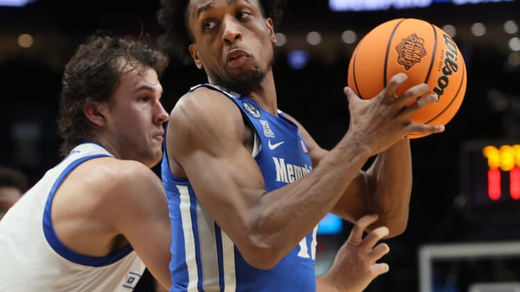 Memphis Tigers forward DeAndre Williams spins past Boise State Broncos forward Tyson Degenhart during their first round NCAA Tournament matchup on Thursday, March 17, 2022 at the Moda Center in Portland, Ore.Jrca1602