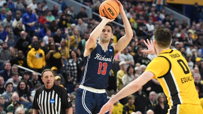 Mar 17, 2022; Buffalo, NY, USA; Richmond Spiders guard Connor Crabtree (13) shoots the ball against Iowa Hawkeyes forward Filip Rebraca (0) in the second half during the first round of the 2022 NCAA Tournament at KeyBank Center. Mandatory Credit: Mark Konezny-USA TODAY Sports