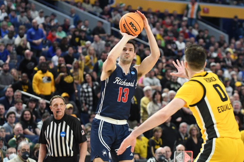 Mar 17, 2022; Buffalo, NY, USA; Richmond Spiders guard Connor Crabtree (13) shoots the ball against Iowa Hawkeyes forward Filip Rebraca (0) in the second half during the first round of the 2022 NCAA Tournament at KeyBank Center. Mandatory Credit: Mark Konezny-USA TODAY Sports