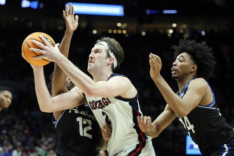 Mar 17, 2022; Portland, OR, USA; Gonzaga Bulldogs forward Drew Timme (2) shoots against Georgia State Panthers guard Kane Williams (12) and guard Collin Moore (24) in the second half during the first round of the 2022 NCAA Tournament at Moda Center. Mandatory Credit: Soobum Im-USA TODAY Sports