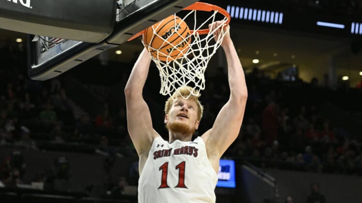 Mar 17, 2022; Portland, OR, USA; Saint Mary's Gaels forward Matthias Tass (11) dunks the basketball against the Indiana Hoosiers during the second half during the first round of the 2022 NCAA Tournament at Moda Center. Mandatory Credit: Troy Wayrynen-USA TODAY Sports