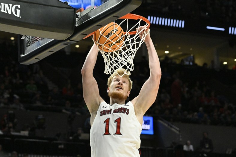Mar 17, 2022; Portland, OR, USA; Saint Mary's Gaels forward Matthias Tass (11) dunks the basketball against the Indiana Hoosiers during the second half during the first round of the 2022 NCAA Tournament at Moda Center. Mandatory Credit: Troy Wayrynen-USA TODAY Sports