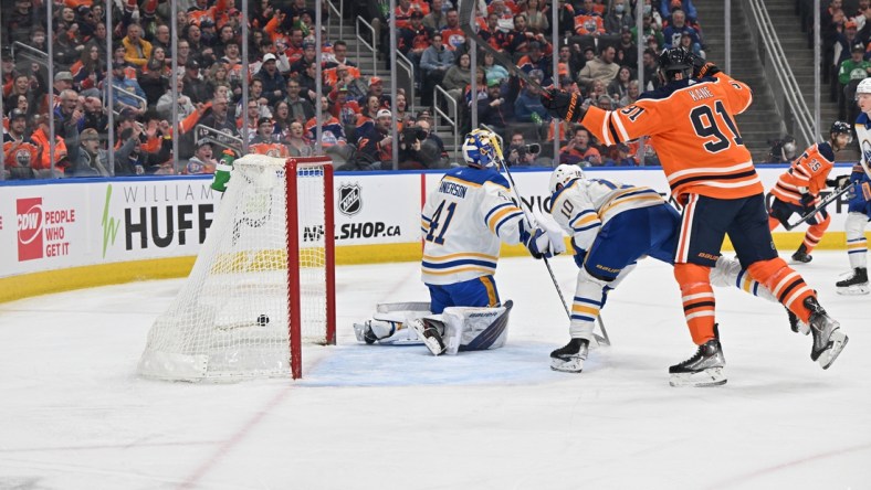 Mar 17, 2022; Edmonton, Alberta, CAN;  Buffalo Sabres goalie Craig Anderson (41) looks on as the the puck streaks past him as Sabres defenceman Henri Jokiharju (10) skates past as Edmonton Oilers left winger Evnder Kane (91) looks on during the first period at Rogers Place. Mandatory Credit: Walter Tychnowicz-USA TODAY Sports