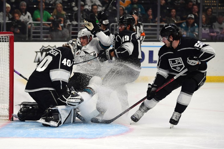 Mar 17, 2022; Los Angeles, California, USA; San Jose Sharks left wing Matt Nieto (83) collides with Los Angeles Kings goaltender Cal Petersen (40) during the first period at Crypto.com Arena. Mandatory Credit: Gary A. Vasquez-USA TODAY Sports