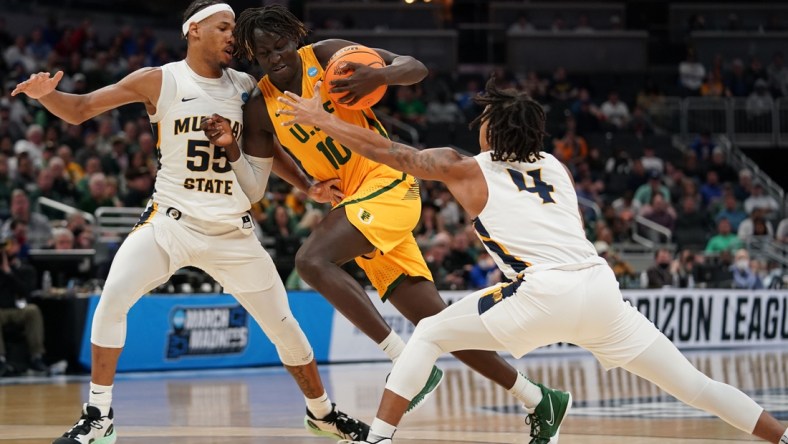 Mar 17, 2022; Indianapolis, IN, USA; San Francisco Dons forward Josh Kunen (10) attempts to dribble past Murray State Racers guard Dionte Bostick (4) and forward DJ Burns (55) in the first half during the first round of the 2022 NCAA Tournament at Gainbridge Fieldhouse. Mandatory Credit: Trevor Ruszkowski-USA TODAY Sports