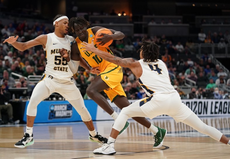 Mar 17, 2022; Indianapolis, IN, USA; San Francisco Dons forward Josh Kunen (10) attempts to dribble past Murray State Racers guard Dionte Bostick (4) and forward DJ Burns (55) in the first half during the first round of the 2022 NCAA Tournament at Gainbridge Fieldhouse. Mandatory Credit: Trevor Ruszkowski-USA TODAY Sports