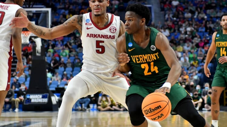 Mar 17, 2022; Buffalo, NY, USA; Vermont Catamounts guard Ben Shungu (24) dribbles against Arkansas Razorbacks guard Au'Diese Toney (5) in the first half during the first round of the 2022 NCAA Tournament at KeyBank Center. Mandatory Credit: Mark Konezny-USA TODAY Sports