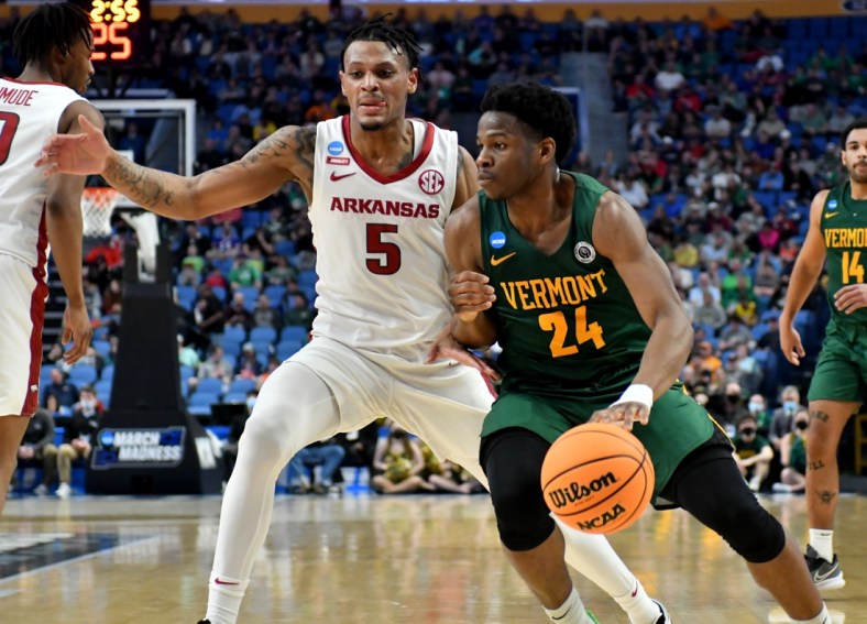 Mar 17, 2022; Buffalo, NY, USA; Vermont Catamounts guard Ben Shungu (24) dribbles against Arkansas Razorbacks guard Au'Diese Toney (5) in the first half during the first round of the 2022 NCAA Tournament at KeyBank Center. Mandatory Credit: Mark Konezny-USA TODAY Sports