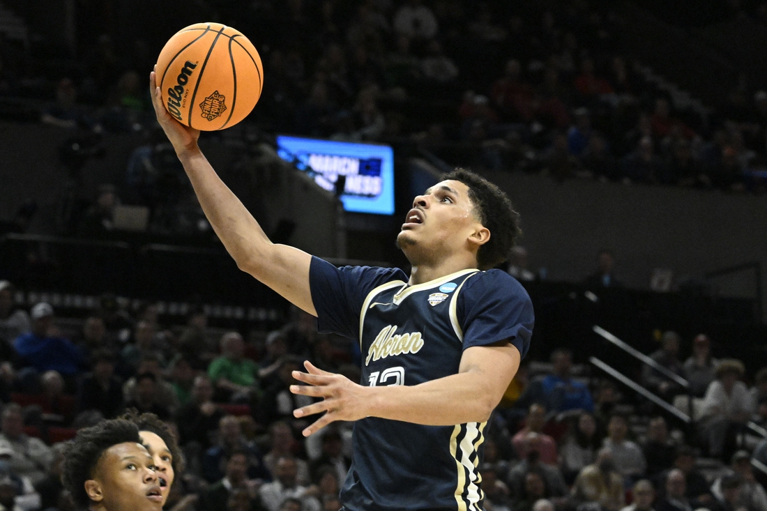 Mar 17, 2022; Portland, OR, USA; Akron Zips guard Xavier Castaneda (13) shoots the basketball against the UCLA Bruins during the second half during the first round of the 2022 NCAA Tournament at Moda Center. Mandatory Credit: Troy Wayrynen-USA TODAY Sports