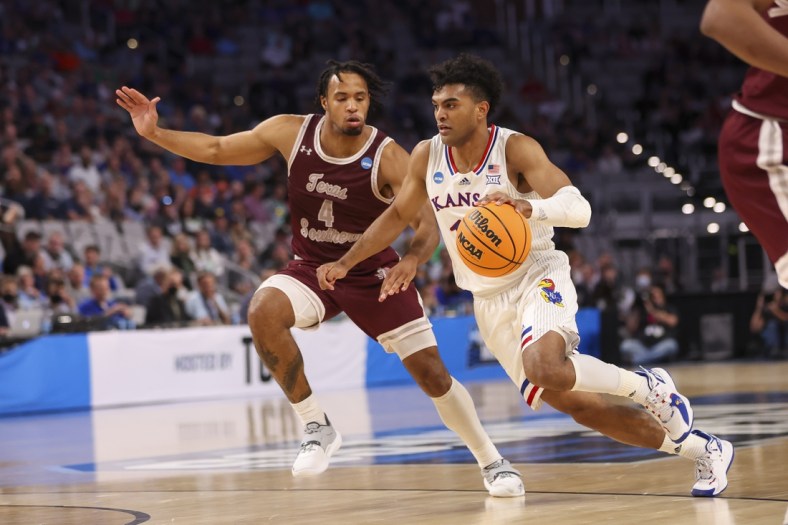 Mar 17, 2022; Fort Worth, TX, USA; Kansas Jayhawks guard Remy Martin (11) durables the ball past Texas Southern Tigers guard Bryson Etienne (4) during the first half in the first round of the 2022 NCAA Tournament at Dickies Arena. Mandatory Credit: Kevin Jairaj-USA TODAY Sports