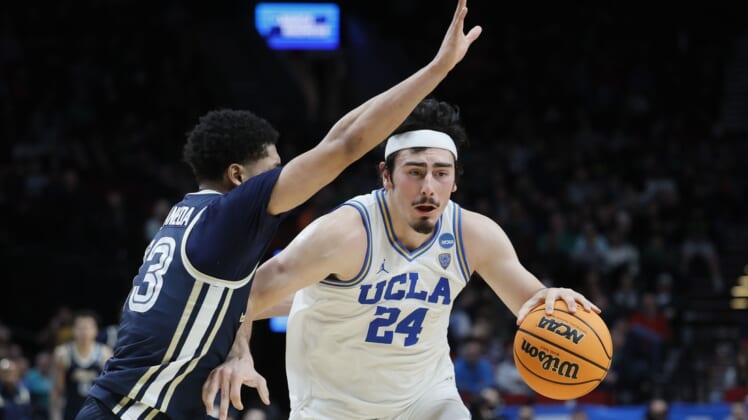 Mar 17, 2022; Portland, OR, USA; UCLA Bruins guard Jaime Jaquez Jr. (24) dribbles the basketball against Akron Zips guard Xavier Castaneda (13) during the second half during the first round of the 2022 NCAA Tournament at Moda Center. Mandatory Credit: Soobum Im-USA TODAY Sports