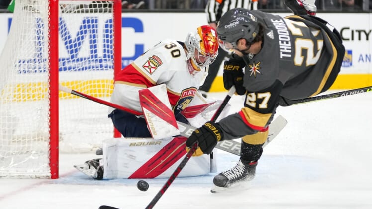 Mar 17, 2022; Las Vegas, Nevada, USA; Florida Panthers goaltender Spencer Knight (30) makes a save against Vegas Golden Knights defenseman Shea Theodore (27) during the second period at T-Mobile Arena. Mandatory Credit: Stephen R. Sylvanie-USA TODAY Sports