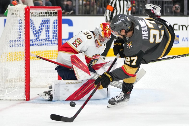 Mar 17, 2022; Las Vegas, Nevada, USA; Florida Panthers goaltender Spencer Knight (30) makes a save against Vegas Golden Knights defenseman Shea Theodore (27) during the second period at T-Mobile Arena. Mandatory Credit: Stephen R. Sylvanie-USA TODAY Sports