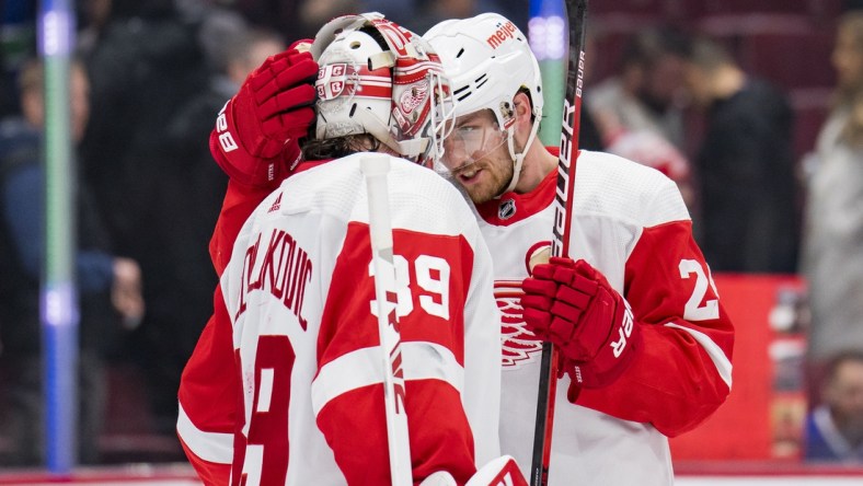 Mar 17, 2022; Vancouver, British Columbia, CAN; Detroit Red Wings goalie Alex Nedeljkovic (39) and forward Pius Suter (24) celebrate their victory against the Vancouver Canucks at Rogers Arena. Detroit won 1-0. Mandatory Credit: Bob Frid-USA TODAY Sports