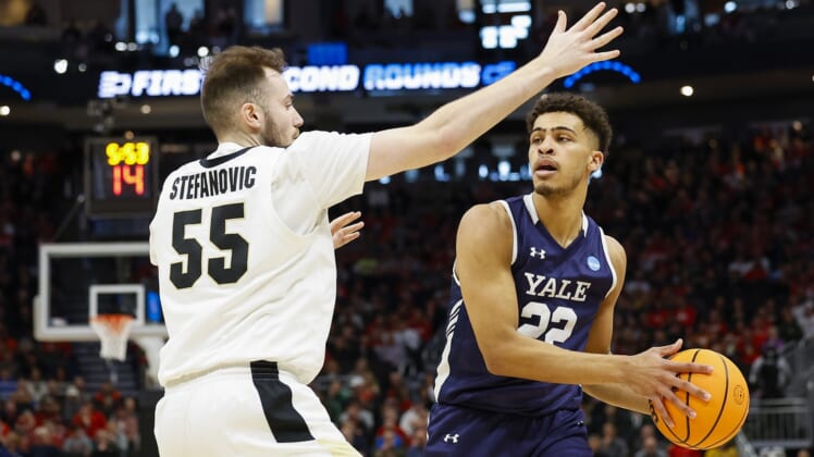 Mar 18, 2022; Milwaukee, WI, USA; Yale Bulldogs forward Matt Knowling (22) controls the ball as Purdue Boilermakers guard Sasha Stefanovic (55) defends during the first half in the first round of the 2022 NCAA Tournament at Fiserv Forum. Mandatory Credit: Jeff Hanisch-USA TODAY Sports