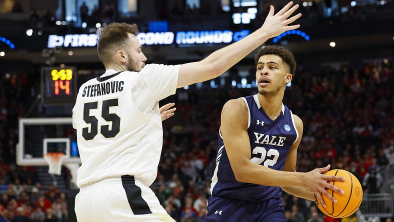 Mar 18, 2022; Milwaukee, WI, USA; Yale Bulldogs forward Matt Knowling (22) controls the ball as Purdue Boilermakers guard Sasha Stefanovic (55) defends during the first half in the first round of the 2022 NCAA Tournament at Fiserv Forum. Mandatory Credit: Jeff Hanisch-USA TODAY Sports