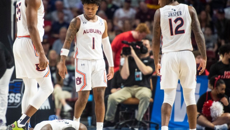 Auburn Tigers forward Jaylin Williams (2) goes down with a mouth injury during the first round of the 2022 NCAA tournament at Bon Secours Wellness Arena in Greenville, S.C., on Friday, March 18, 2022. Auburn Tigers defeated Jacksonville State Gamecocks 80-61.