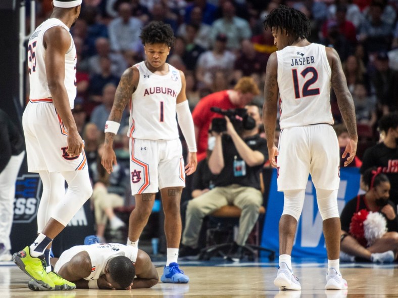 Auburn Tigers forward Jaylin Williams (2) goes down with a mouth injury during the first round of the 2022 NCAA tournament at Bon Secours Wellness Arena in Greenville, S.C., on Friday, March 18, 2022. Auburn Tigers defeated Jacksonville State Gamecocks 80-61.