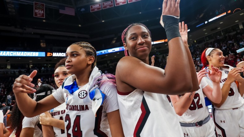 Mar 18, 2022; Columbia, South Carolina, USA; South Carolina Gamecocks guard LeLe Grissett (24) and South Carolina Gamecocks forward Aliyah Boston (4) celebrate their win over the Howard Lady Bison at Colonial Life Arena. Mandatory Credit: Jeff Blake-USA TODAY Sports