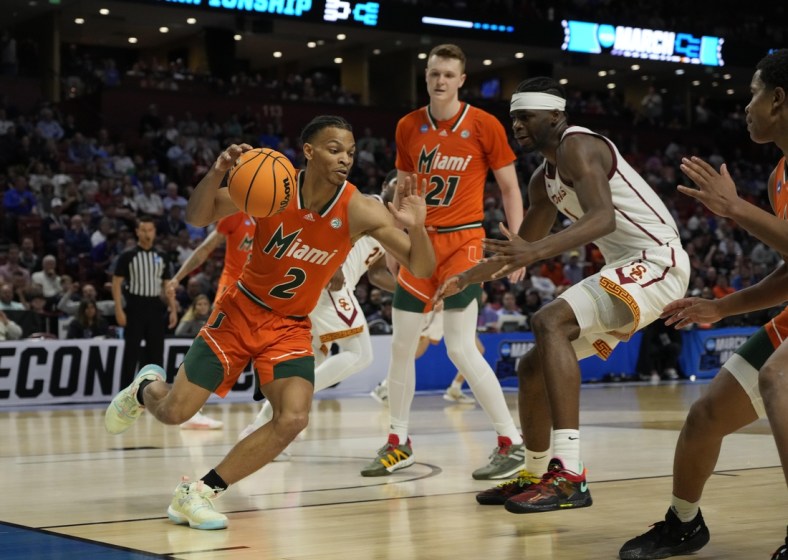 Mar 18, 2022; Greenville, SC, USA; Miami Hurricanes guard Isaiah Wong (2) drives to the basket against Southern California Trojans forward Chevez Goodwin (1) during the first round of the 2022 NCAA Tournament at Bon Secours Wellness Arena. Mandatory Credit: Jim Dedmon-USA TODAY Sports