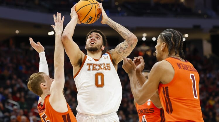Mar 18, 2022; Milwaukee, WI, USA; Texas Longhorns forward Timmy Allen (0) shoots against Virginia Tech Hokies guard Storm Murphy (5) during the first half in the first round of the 2022 NCAA Tournament at Fiserv Forum. Mandatory Credit: Jeff Hanisch-USA TODAY Sports
