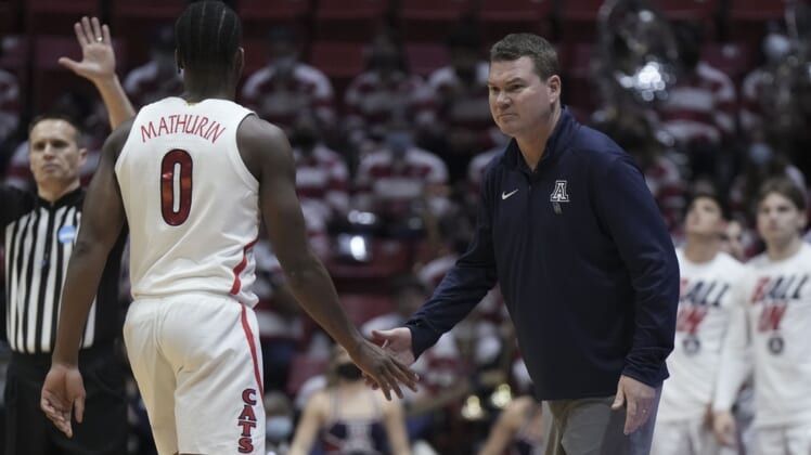 Mar 18, 2022; San Diego, CA, USA; Arizona Wildcats head coach Tommy Lloyd (right) high-fives guard Bennedict Mathurin (0) against the Wright State Raiders during the first half during the first round of the 2022 NCAA Tournament at Viejas Arena. Mandatory Credit: Kirby Lee-USA TODAY Sports