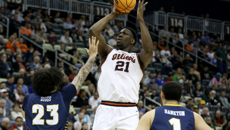 Mar 18, 2022; Pittsburgh, PA, USA; Illinois Fighting Illini center Kofi Cockburn (21) shoots over Chattanooga Mocs center Avery Diggs (23) in the first half during the first round of the 2022 NCAA Tournament at PPG Paints Arena. Mandatory Credit: Charles LeClaire-USA TODAY Sports