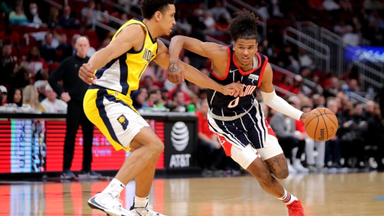 Mar 18, 2022; Houston, Texas, USA; Houston Rockets guard Jalen Green (0, right) handles the ball defended by Indiana Pacers guard Malcolm Brogdon (&) during the second quarter at Toyota Center. Mandatory Credit: Erik Williams-USA TODAY Sports
