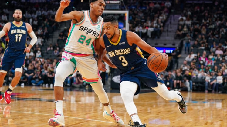 Mar 18, 2022; San Antonio, Texas, USA;  New Orleans Pelicans guard CJ McCollum (3) dribbles against San Antonio Spurs guard Devin Vassell (24) in the first half at the AT&T Center. Mandatory Credit: Daniel Dunn-USA TODAY Sports