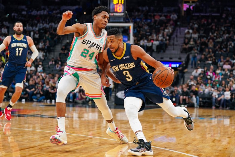 Mar 18, 2022; San Antonio, Texas, USA;  New Orleans Pelicans guard CJ McCollum (3) dribbles against San Antonio Spurs guard Devin Vassell (24) in the first half at the AT&T Center. Mandatory Credit: Daniel Dunn-USA TODAY Sports