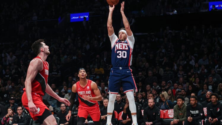 Mar 18, 2022; Brooklyn, New York, USA; Brooklyn Nets guard Seth Curry (30) shoots the ball as Portland Trail Blazers guard Josh Hart (11) defends during the second half at Barclays Center. Mandatory Credit: Vincent Carchietta-USA TODAY Sports