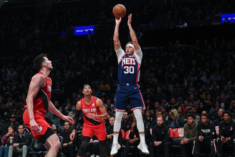 Mar 18, 2022; Brooklyn, New York, USA; Brooklyn Nets guard Seth Curry (30) shoots the ball as Portland Trail Blazers guard Josh Hart (11) defends during the second half at Barclays Center. Mandatory Credit: Vincent Carchietta-USA TODAY Sports