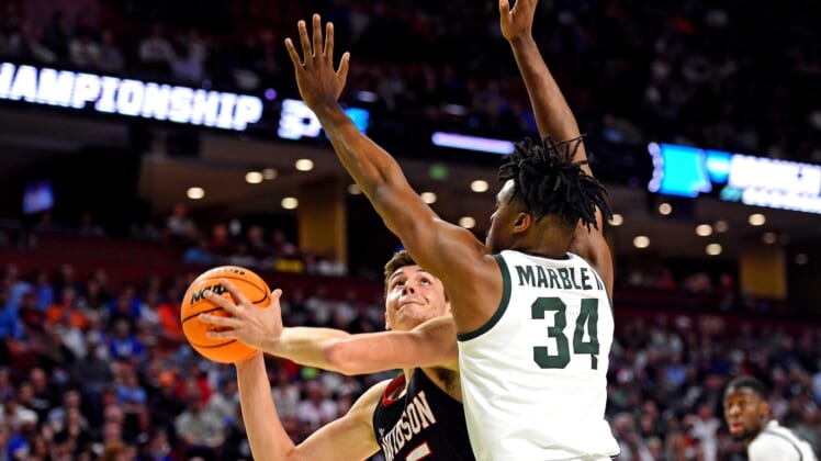 Mar 18, 2022; Greenville, SC, USA; Davidson Wildcats forward Luka Brajkovic (35) shoots the ball against Michigan State Spartans forward Julius Marble II (34) during the first round of the 2022 NCAA Tournament at Bon Secours Wellness Arena. Mandatory Credit: Bob Donnan-USA TODAY Sports