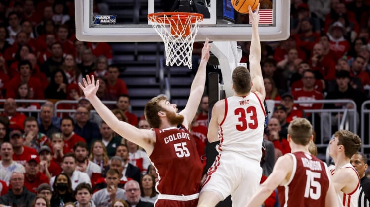 Mar 18, 2022; Milwaukee, WI, USA; Colgate Raiders center Jeff Woodward (55) defends as Wisconsin Badgers center Chris Vogt (33) drives to the basket in the first half during the second round of the 2022 NCAA Tournament at Fiserv Forum. Mandatory Credit: Jeff Hanisch-USA TODAY Sports