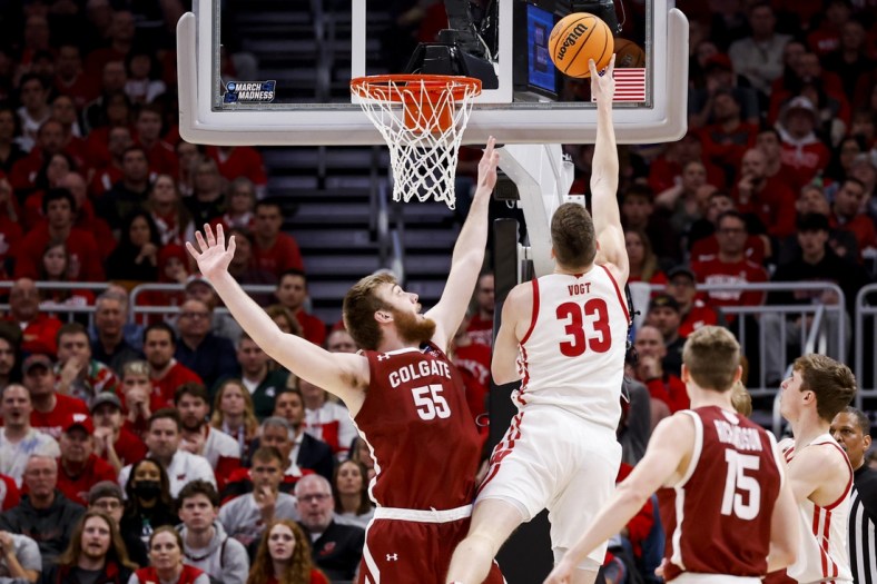 Mar 18, 2022; Milwaukee, WI, USA; Colgate Raiders center Jeff Woodward (55) defends as Wisconsin Badgers center Chris Vogt (33) drives to the basket in the first half during the second round of the 2022 NCAA Tournament at Fiserv Forum. Mandatory Credit: Jeff Hanisch-USA TODAY Sports