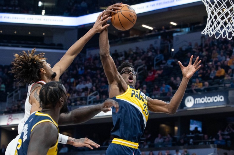 Mar 20, 2022; Indianapolis, Indiana, USA;  Indiana Pacers forward Jalen Smith (25) rebounds the ball in the first half against the Portland Trail Blazers at Gainbridge Fieldhouse. Mandatory Credit: Trevor Ruszkowski-USA TODAY Sports