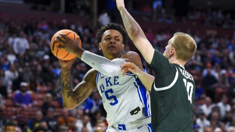 Mar 20, 2022; Greenville, SC, USA; Duke Blue Devils forward Paolo Banchero (5) carries the ball against Michigan State Spartans forward Joey Hauser (10) in the first half during the second round of the 2022 NCAA Tournament at Bon Secours Wellness Arena. Mandatory Credit: Bob Donnan-USA TODAY Sports